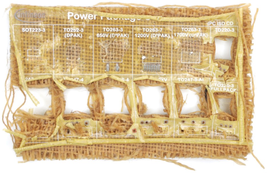 A dissassembled Infineon Soluboard, a recyclable PCB, showing the non-toxic polymer dissolving when immersed in hot water, leaving only compostable organic material. 