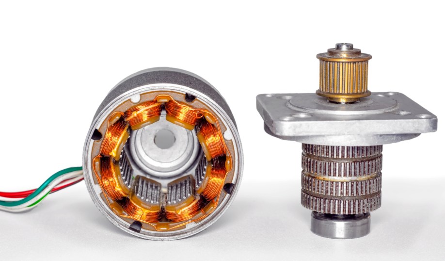 Stepper motor disassembled, with stator on the left and rotor on the right.