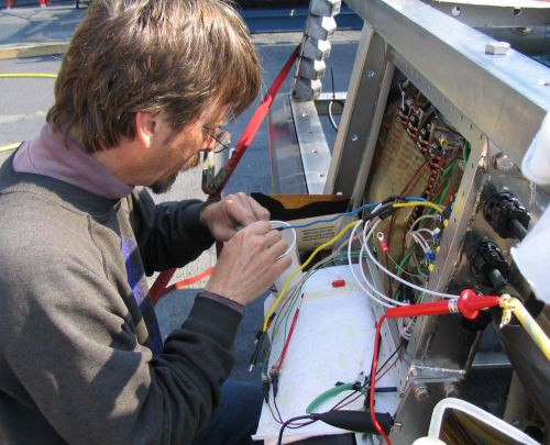 Electrical engineer working on some electrical wires.