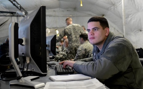 Army member on computer