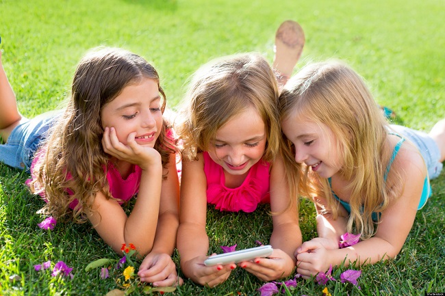 Children with smartphone while outside