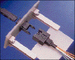 High-density fiber-optic connector simplifies backplane system packaging