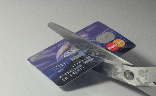 Cutting debit card with scissors