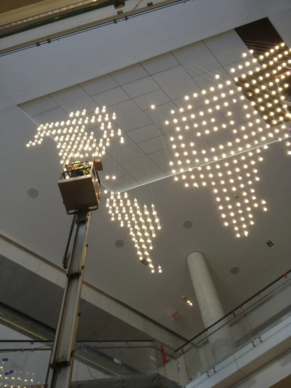 Installing CSIS lobby chandelier