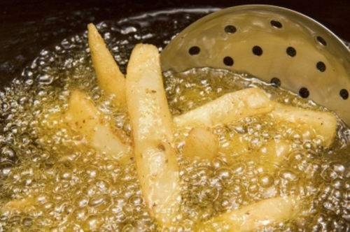 French fries being cooked in oil