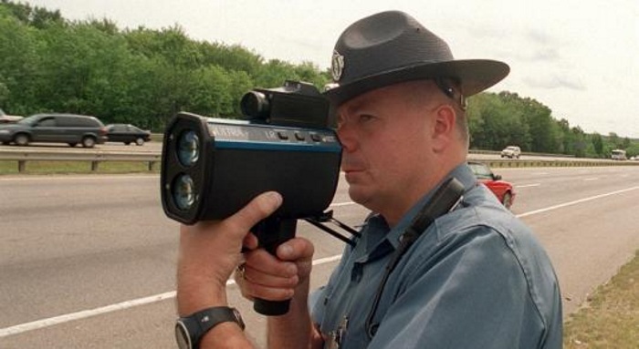 Cop standing with radar gun