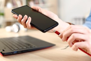 Shutterstock image of smartphone with USB-C cable.