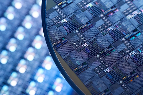 Chip manufacturing showing closeup of silicon wafers.